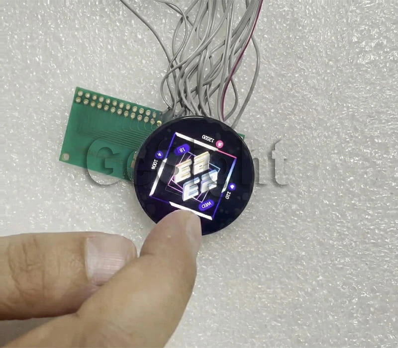 Finger touch test on a 1.43-inch round AMOLED display module during demo operation.